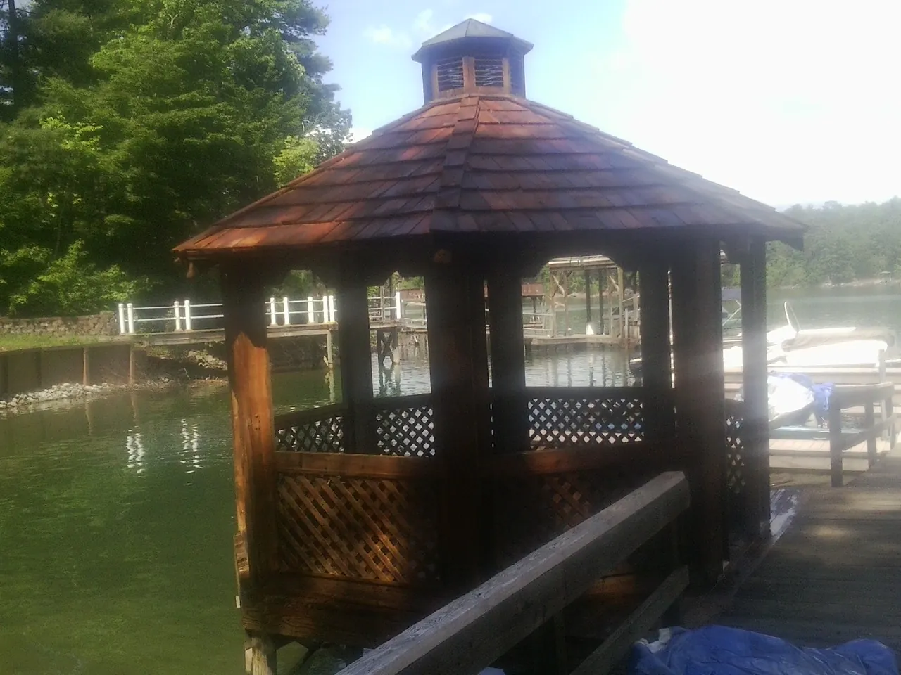 Cedar shake gazebo roof rebuilt on a lake dock in Orleans